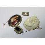 A vegetable ivory cameo brooch in yellow metal mount stamped 14k to hanging bale, an oval portrait