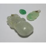 A carved jade pendant of a monkey on a peach, 5.5cm long, together with two other smaller jade
