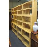 A pair of Ikea satinwood three tier glazed bookcases display cabinets in sections, 210 cm high x 135