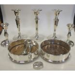 A pair of silver wine coasters, London 1977, a pair of dwarf candlesticks, three matching