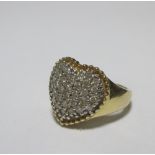 A heart shaped diamond ring, the heart pave set in white metal with small brilliant cut diamonds,