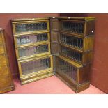 A pair of Globe Wernicke oak sectional bookcases with leaded lights together with a corner