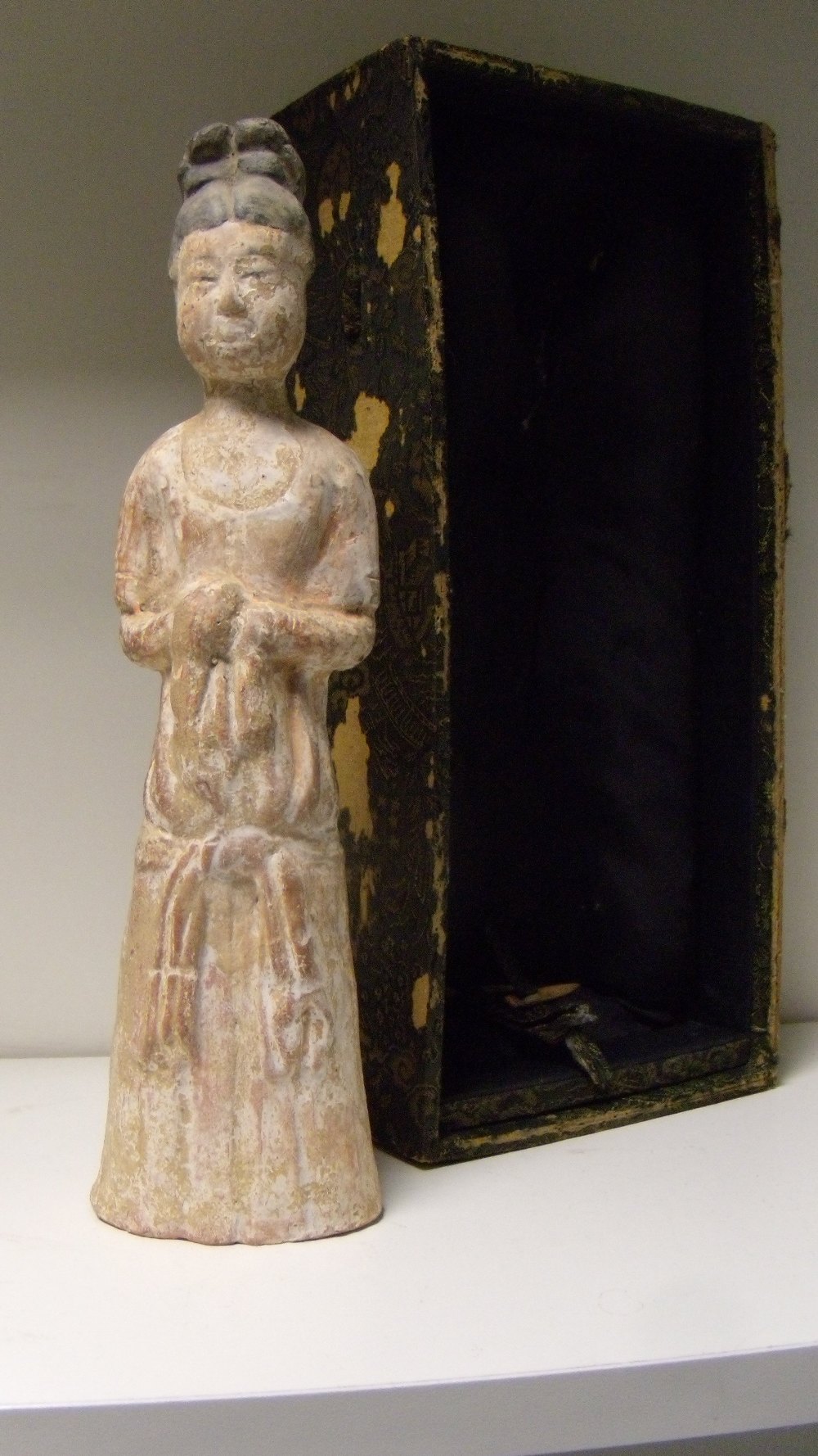 A pottery lady, possibly Tang Dynasty, 28cm (11 in) high  There is no obvious damage beneath both