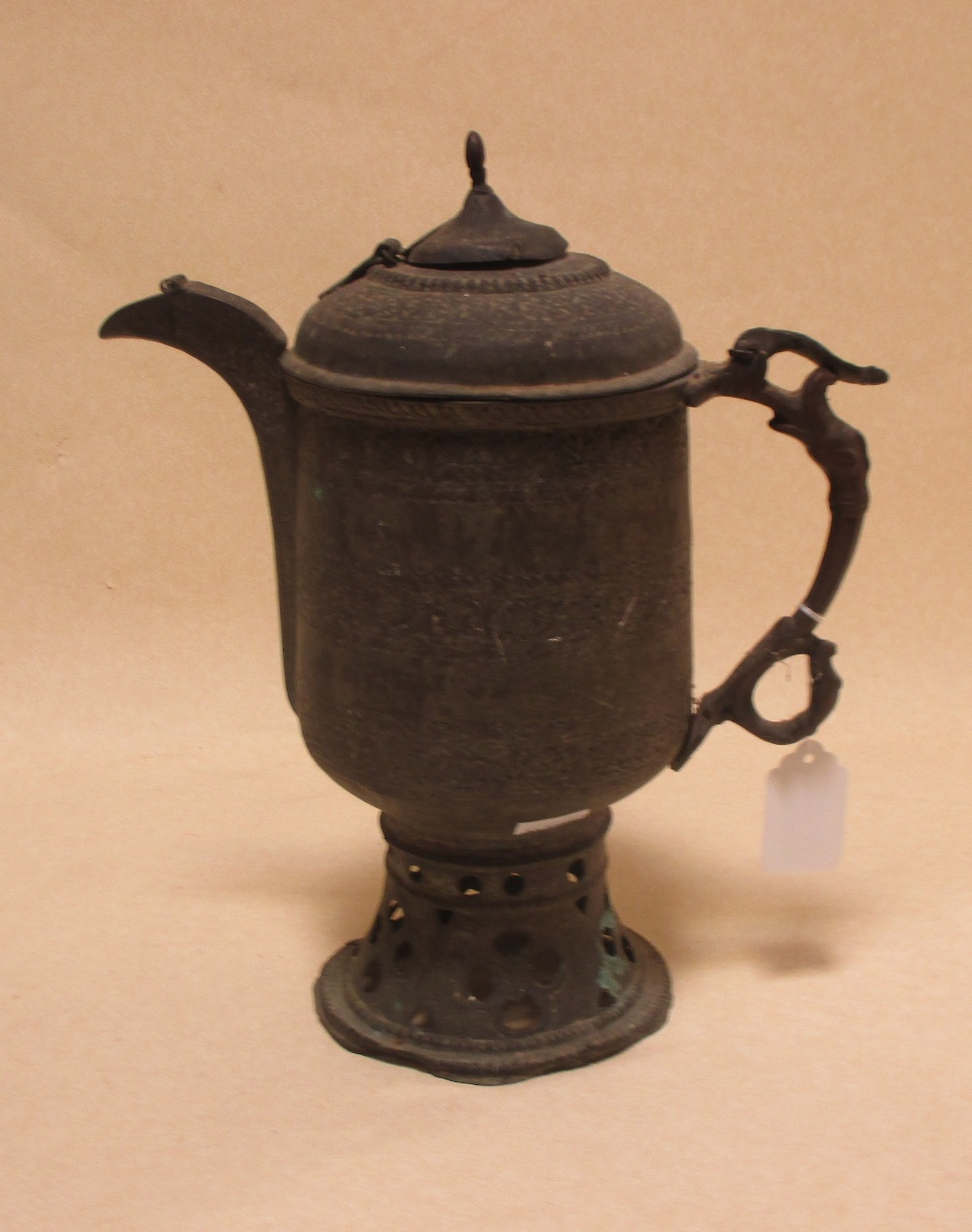An Eastern brass coffee pot
