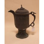 An Eastern brass coffee pot