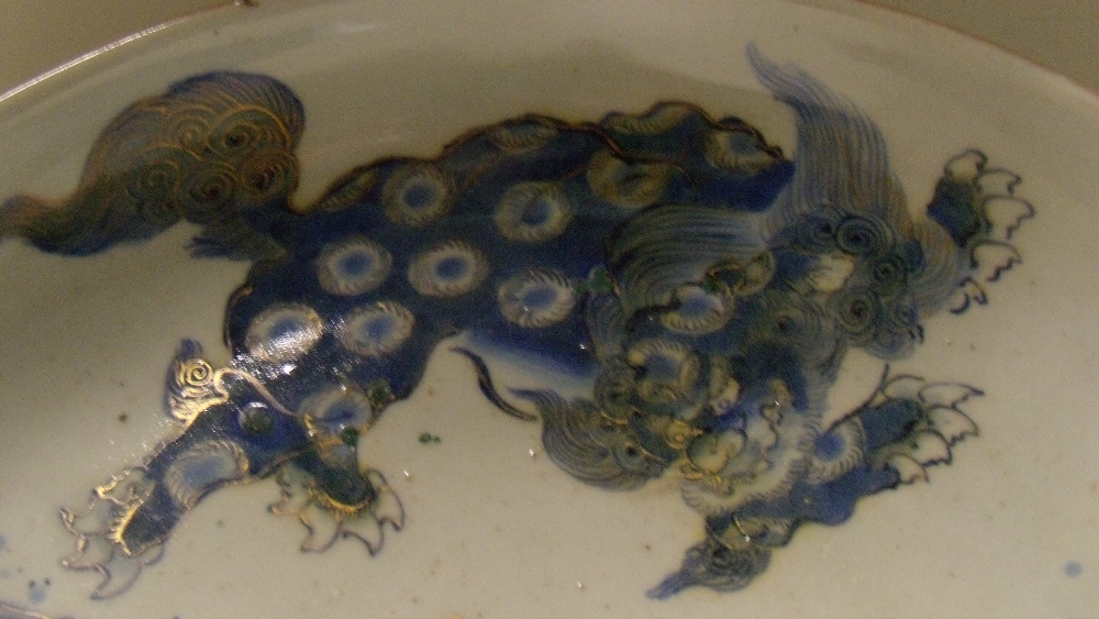 A 19th century Japanese Arita shallow bowl painted in blue and gilt with a shishi, seal mark of - Image 2 of 4