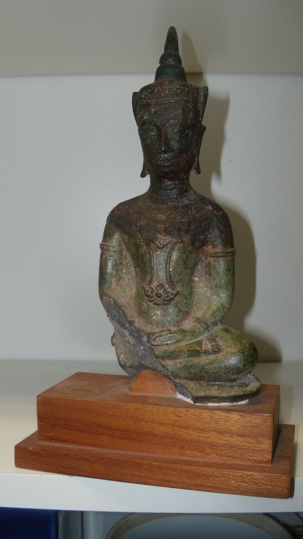 A 16th/17th century bronze Buddha from Ayuthia, Thailand, 20cm (8 in) high  A lable on the wood