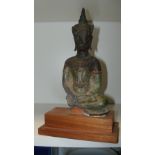 A 16th/17th century bronze Buddha from Ayuthia, Thailand, 20cm (8 in) high  A lable on the wood