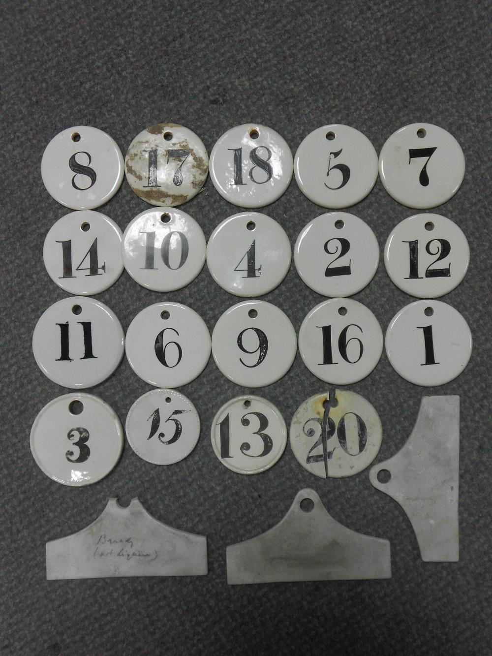 A collection of sixteen Victorian ceramic circular numbered bin labels marked Charles Farrow and