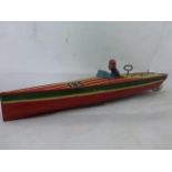 A good Lindstrom clockwork tinplate model of a speedboat with single figure inside.