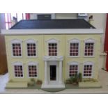 A Georgian style dolls house with accessories including lights.