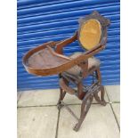 An Edwardian highchair on wheels.