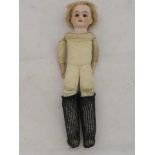 A small bisque headed doll with leather padded body and glass eyes.