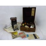 A tan leather cased Polaroid Land Camera Model 95, with various accessories.