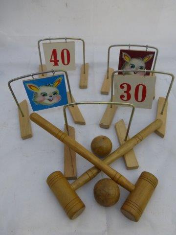 A child's table top croquet set with two balls and two mallets.