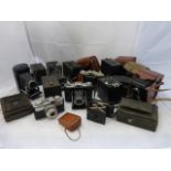 A box of assorted cameras including cine cameras etc.