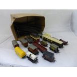 An assortment of model railway OO gauge rolling stock, carriages and track; also a Tri-ang signal.