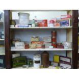Three shelves of chemist products including The People's Champagne Tap, various Elastoplast
