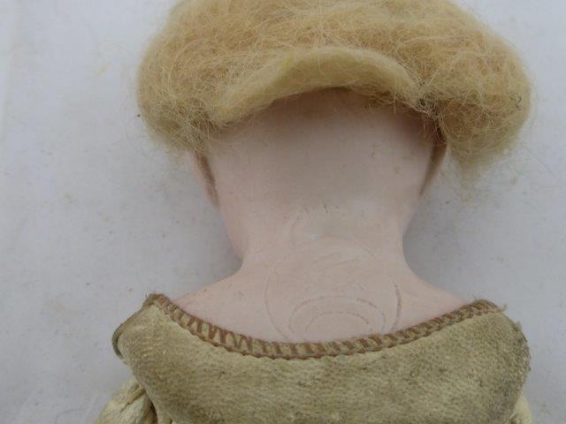 A small bisque headed doll with leather padded body and glass eyes. - Image 2 of 2