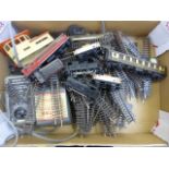 A box of Hornby Dublo model railway items including locomotive, rolling stock, buildings, track