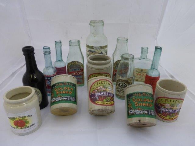 Eighteen labelled food bottles and jars.