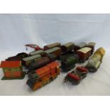 Assorted clockwork O gauge tinplate engines, carriages, rolling stock and track, in playworn