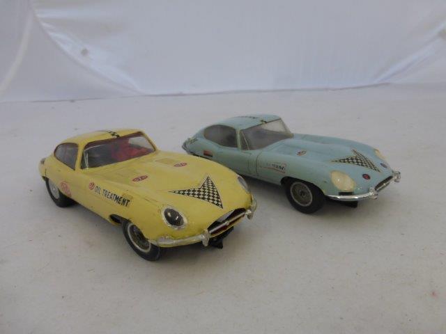 Two Scalextric C34 Jaguar E-types in light blue and cream, playworn (tail pipe missing).