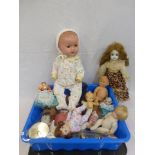 A box of assorted dolls, various sizes.