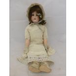 A Heubach Koppelsdorf bisque headed German doll with jointed composition body, sleeping eyes and