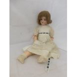 An Armand Marseille bisque headed doll with jointed composite limbs, the head stamped '390 A 7 M',