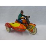 A tinplate clockwork model of a 1930s/40s model of a motorcycle and sidecar with rider.