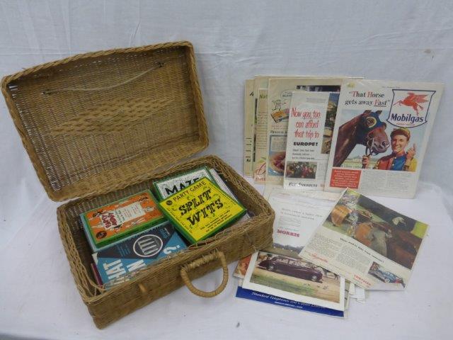 A hamper of assorted games and a selection of advertising prints.