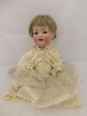 A Simon & Halbig bisque headed doll dressed in silk and lace Christening clothes, stamped 126, 15"