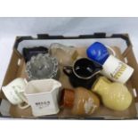 A box of assorted advertising jugs and ashtrays including Halls, Martell, Riding, Cadbury, Wills,