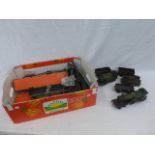 A box of assorted train items to include two sets of rolling stock, trucks, etc.