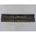 A pair of Cadbury's Chocolate embossed shelf strips.