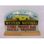 A glass sign for Western National Tours, Private Hire, Parcels, Enquiries loosely set in wooden