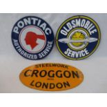 Two circular reproduction American enamel signs relating to Pontiac and Oldsmobile.