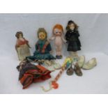 A quantity of mixed dolls, one early wax headed doll; also various doll's shoes, etc.