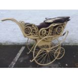 A Victorian painted two seat pram with leather canopy hood and front and rear facing seats,