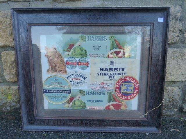 An oak-framed collection of Harris advertising labels.