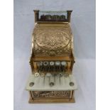 A late Victorian/Edwardian polished bronze till by National, of small proportions.