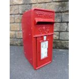 An early post box bearing the letters G.R., with white enamel inserts detailing collections from