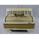 A cased Alvari accordion.