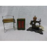 A Remanco miniature tinplate mangle, a similar scale sewing machine and a tinplate money box in