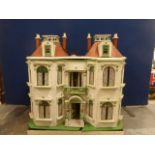 A well made and detailed dolls house model of a double fronted town house, with partial contents.