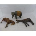 An early grey painted wooden articulated elephant and two similarly made horses.