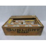 A Sunlight Soap wooden box containing a selection of original Sunlight Soap packaging.