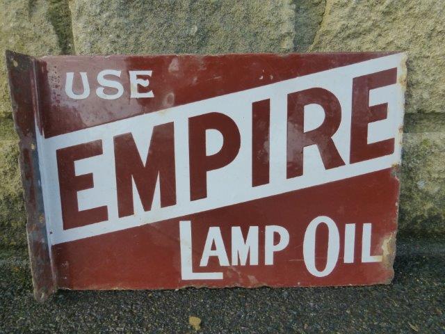 A double sided enamel advertising sign with hanging flange, to one side promoting Empire Lamp Oil,