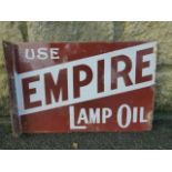 A double sided enamel advertising sign with hanging flange, to one side promoting Empire Lamp Oil,